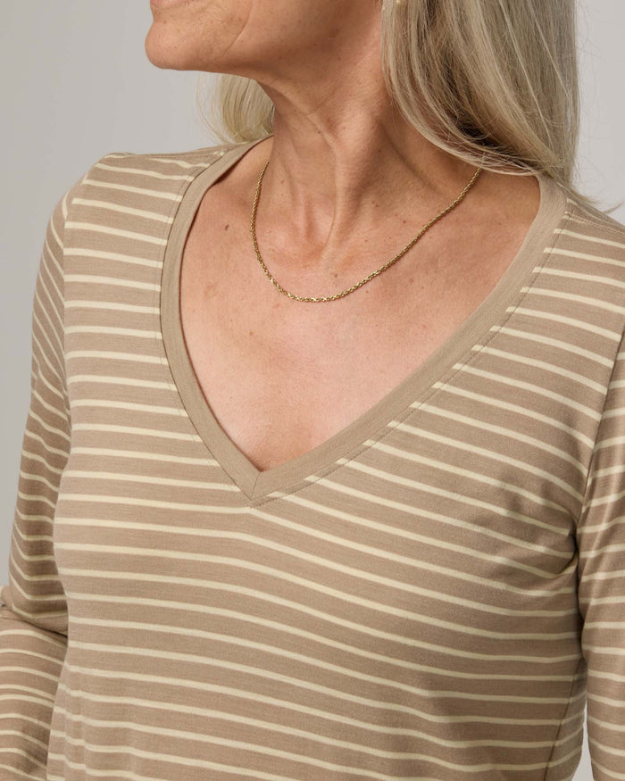 Model wearing Brenton V-Neck Tee in Khaki & Natural White Stripe. Brenton V-Neck Tee is a merino wool long sleeve, v-neck, regular fit tee available in sizes XS-3X.