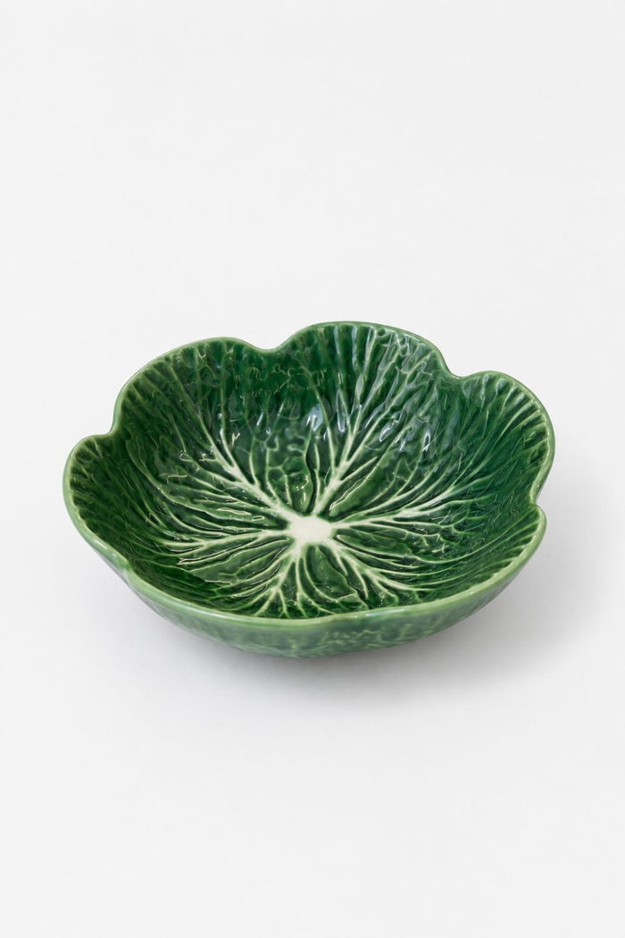 A green ceramic bowl shaped like a leaf, featuring a detailed embossed leaf vein pattern on the interior, set against a plain light gray background.