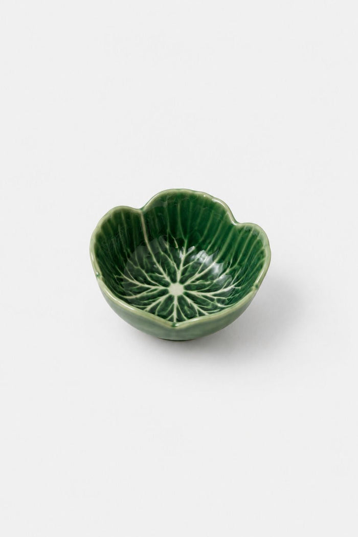 A small green ceramic bowl with a lotus petal shape and a leaf vein pattern printed inside, shown on a light gray background.