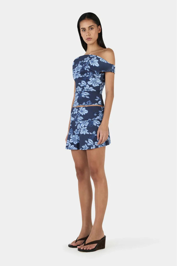 Model wearing a blue floral print skirt and top set