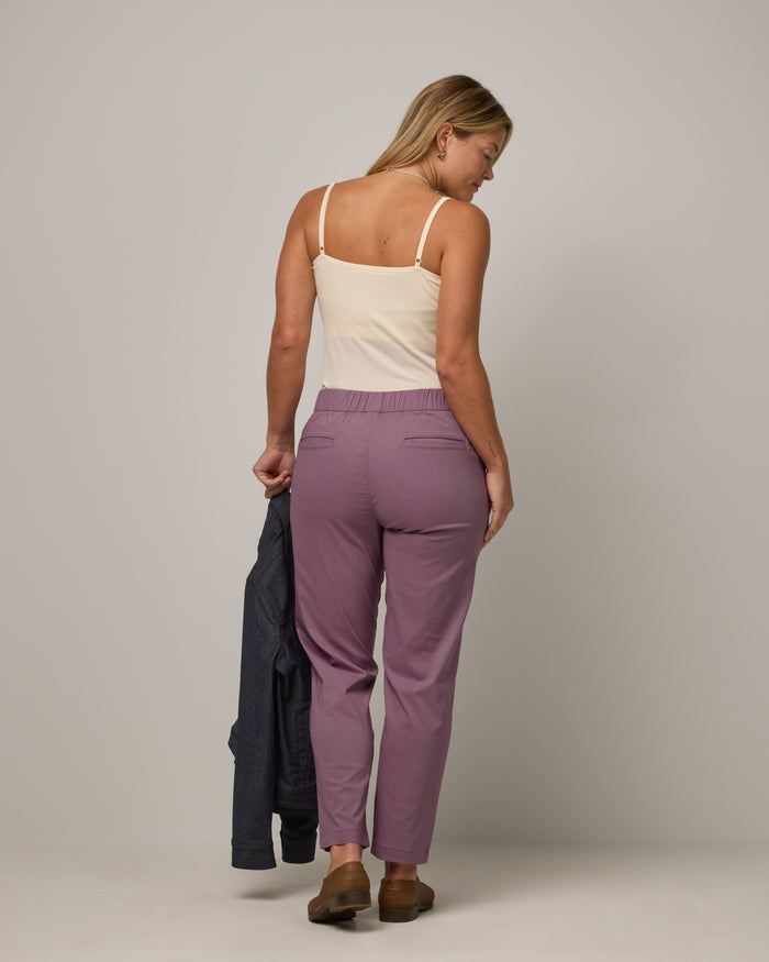 Model wearing Canyon Straight Leg Pant in Lavender. Canyon Straight Leg Pant is a merino wool pant with pockets available in sizes XS-3X Regular and XS-XXL Long.