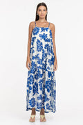 Woman wearing a blue floral dress on a white background