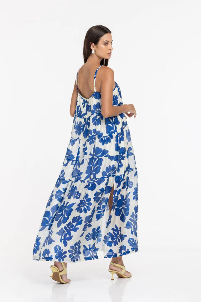 Woman wearing a blue floral dress on a white background