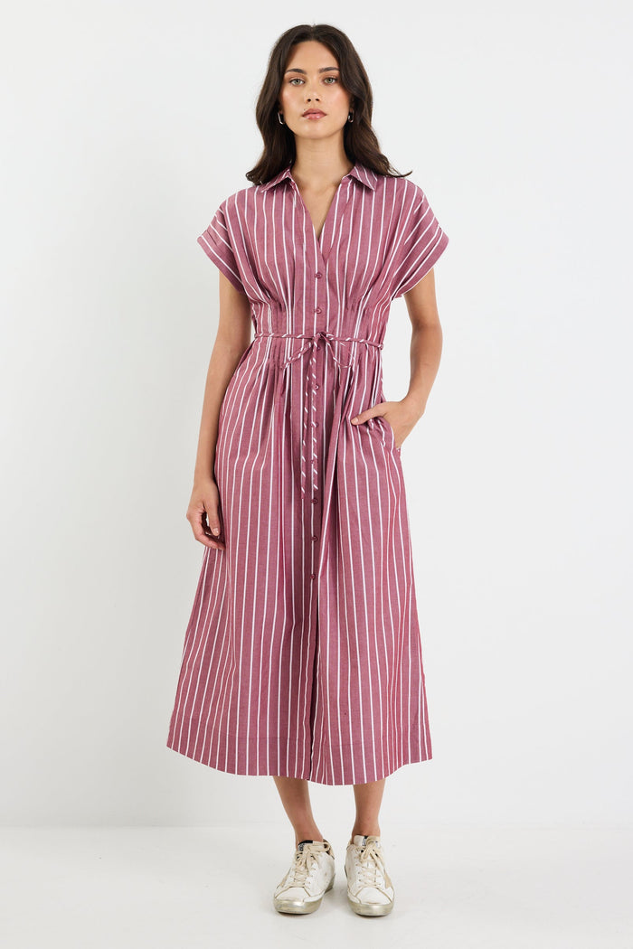 Woman wearing a striped dress on a white background