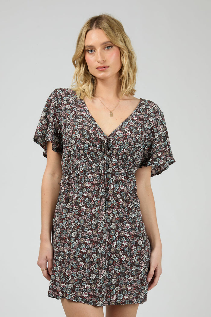 Woman wearing dark purple floral dress