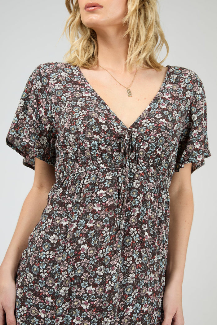 Woman wearing dark purple floral dress
