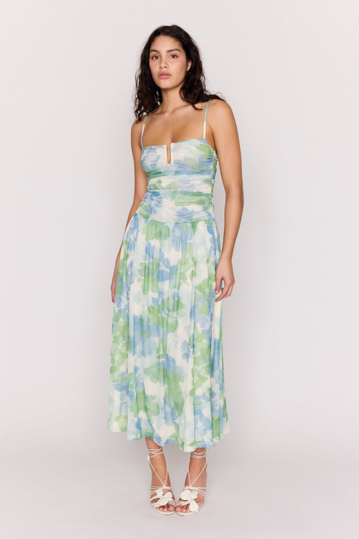 Woman wearing a floral dress on a plain background