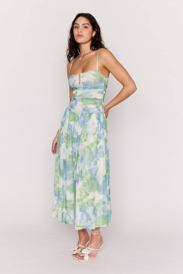 Woman wearing a floral dress against a white background