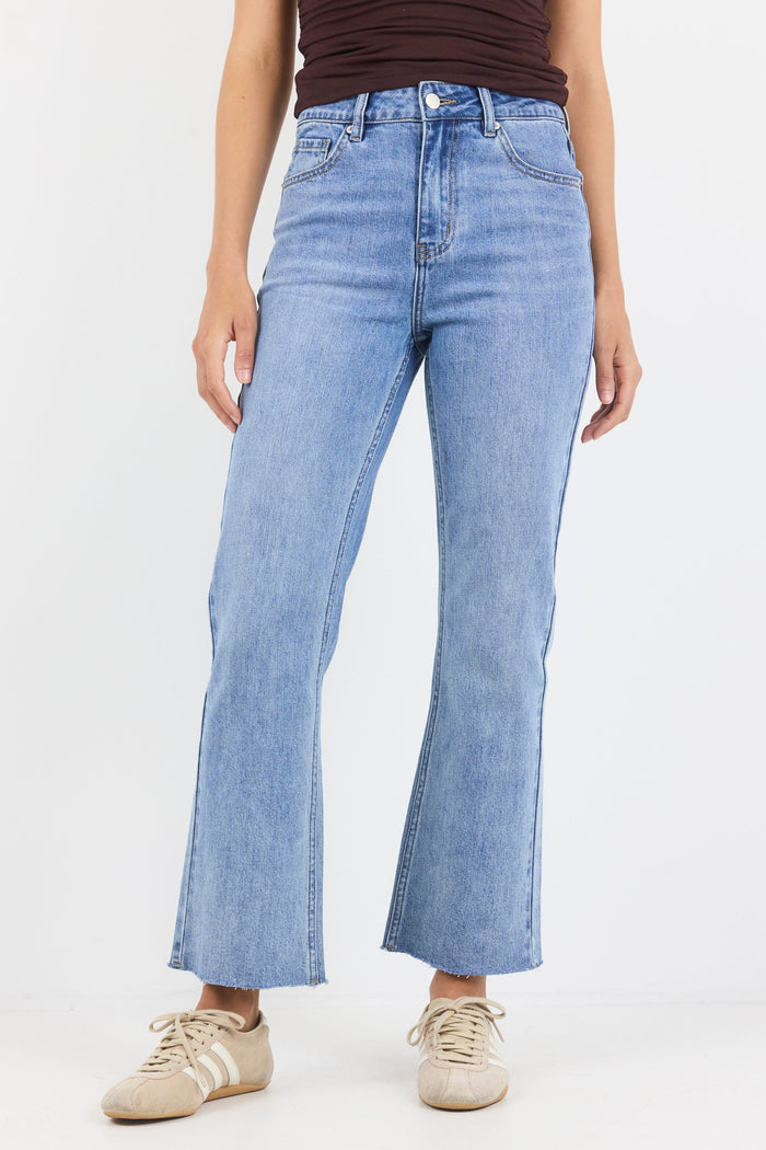 Person wearing light blue jeans on a white background