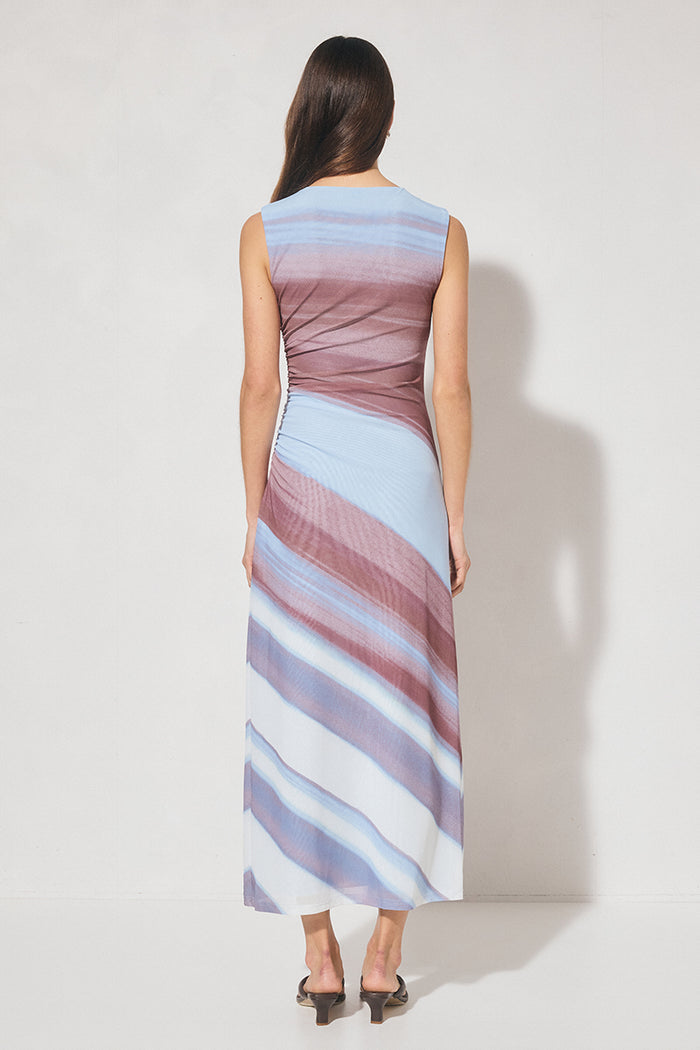 Woman wearing a sleeveless dress with multicolor stripes on a white background