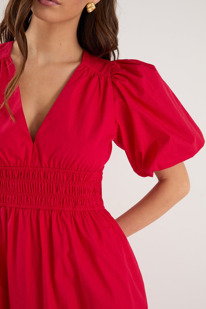 model wearing red puff sleeve dress