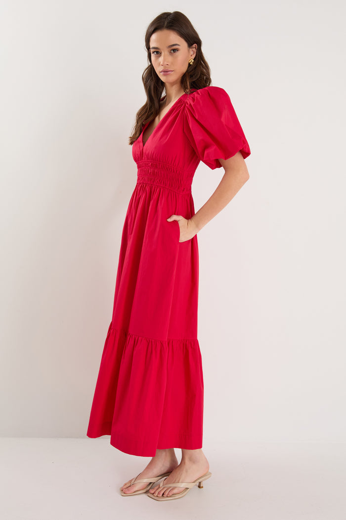 model wearing red puff sleeve dress