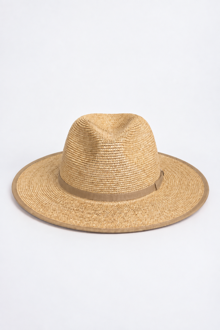 A natural straw fedora hat with a matching tan band, photographed from the side against a clean white background.