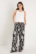 woman wearing black white pant and white top