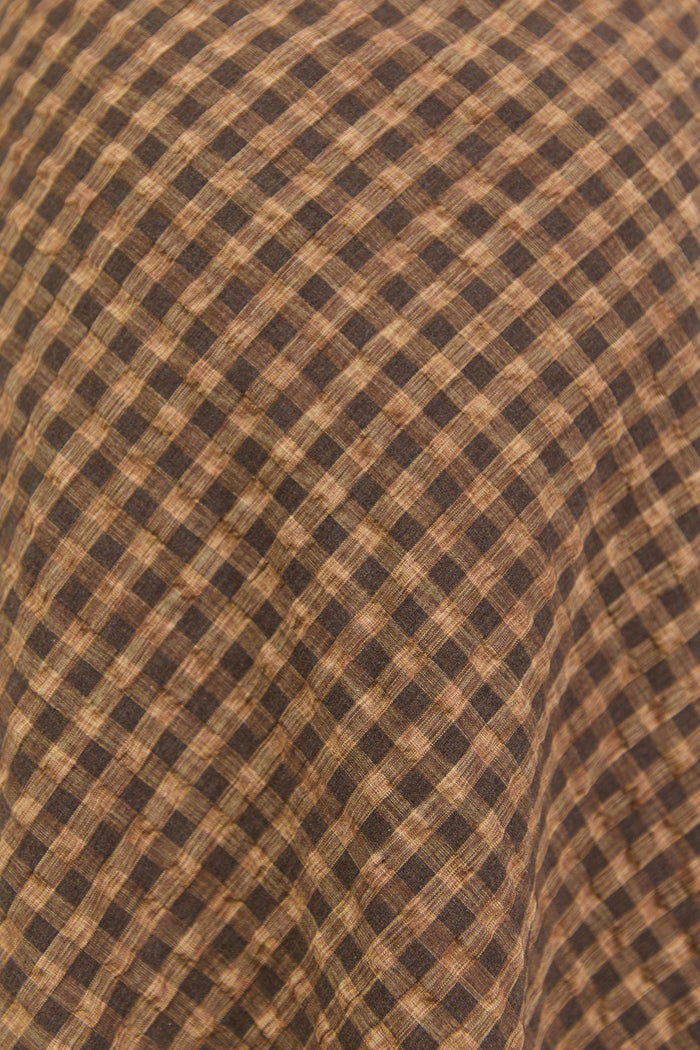 Brown checkered fabric close up.