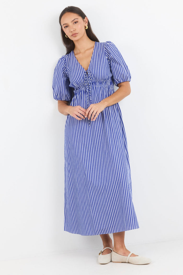 Woman wearing a blue and white striped dress on a white background