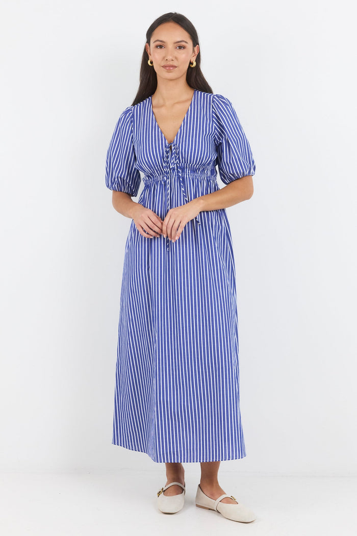 Woman wearing a blue and white striped dress on a white background