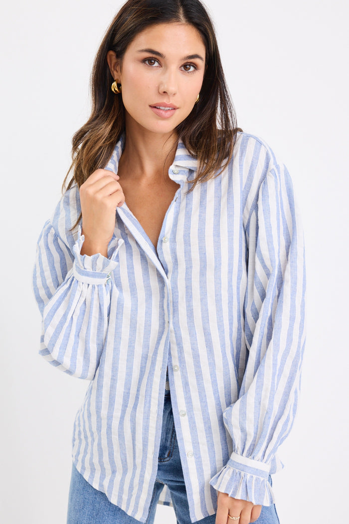 model wears a blue and white stripe shirt and blue jeans