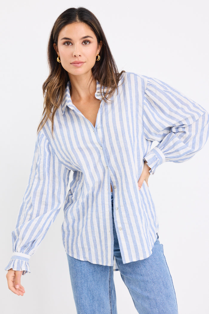 model wears a blue and white stripe shirt and blue jeans