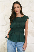 model wearing a green shirred top