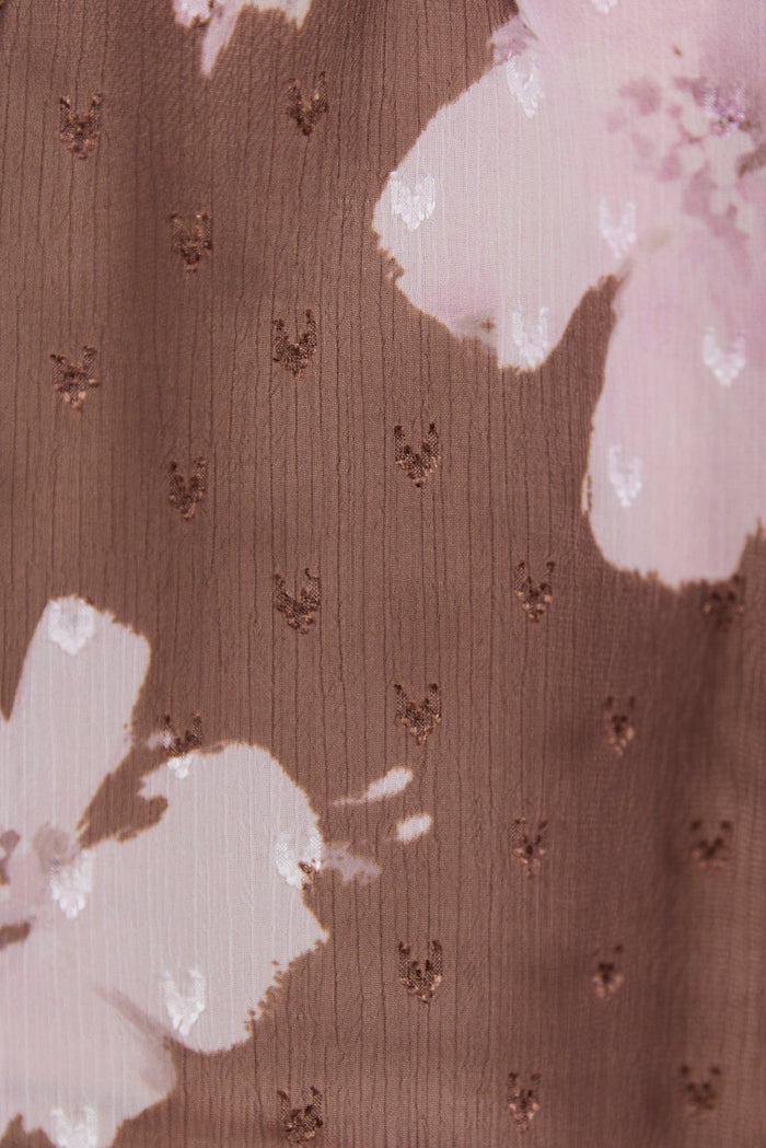 Brown fabric with floral patterns and small shapes