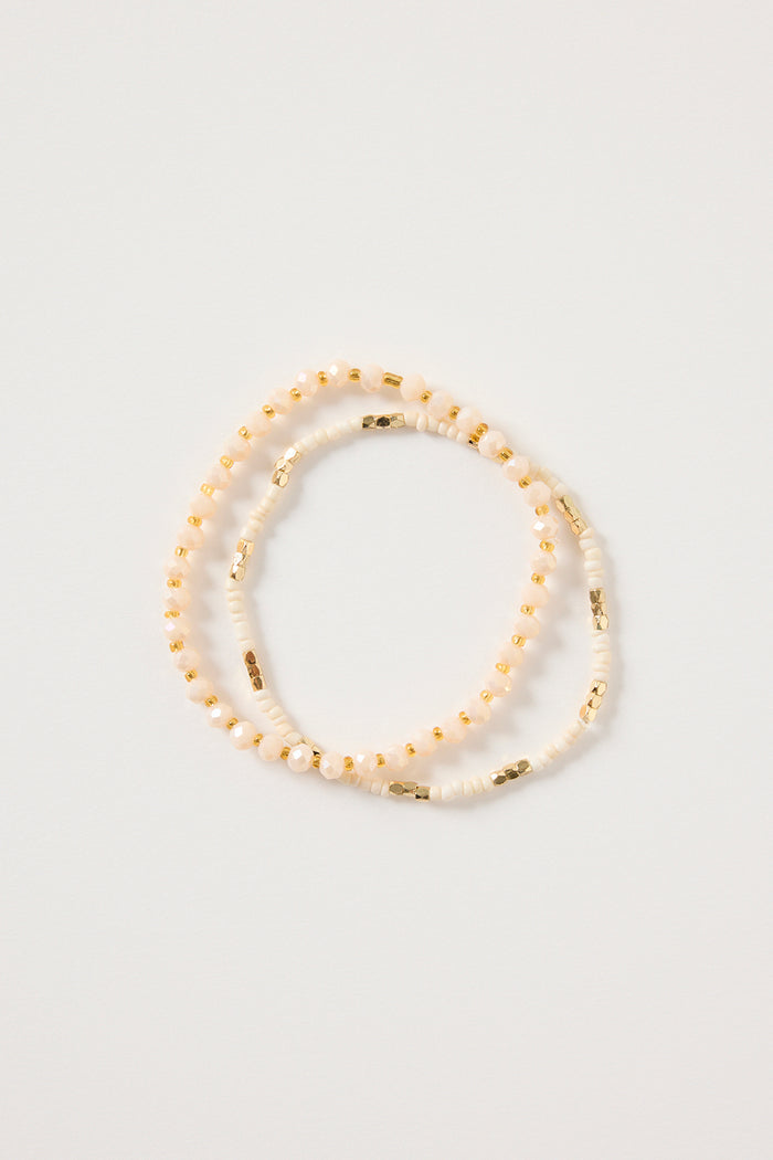 Cream and gold double beaded bracelet featuring mixed ivory beads and metallic gold accents, styled in a layered loop on a white background. Delicate women’s jewellery ideal for stacking, gifting and everyday wear.