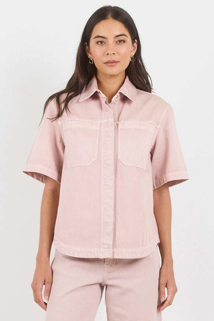 Woman wearing a pink outfit on a white background