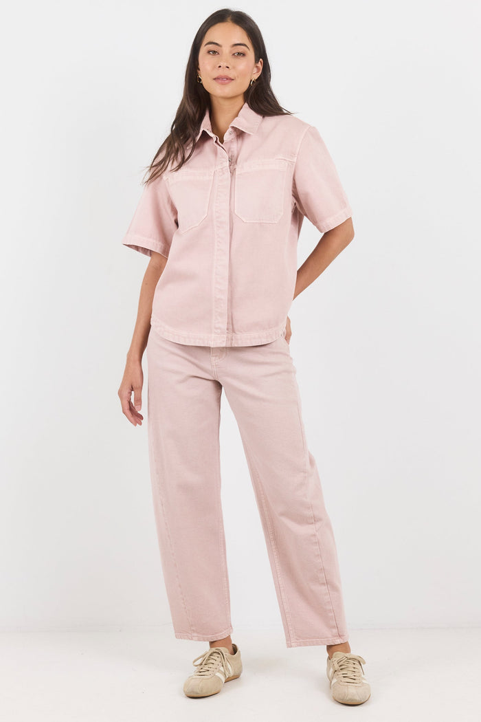 Woman wearing a pink outfit on a white background