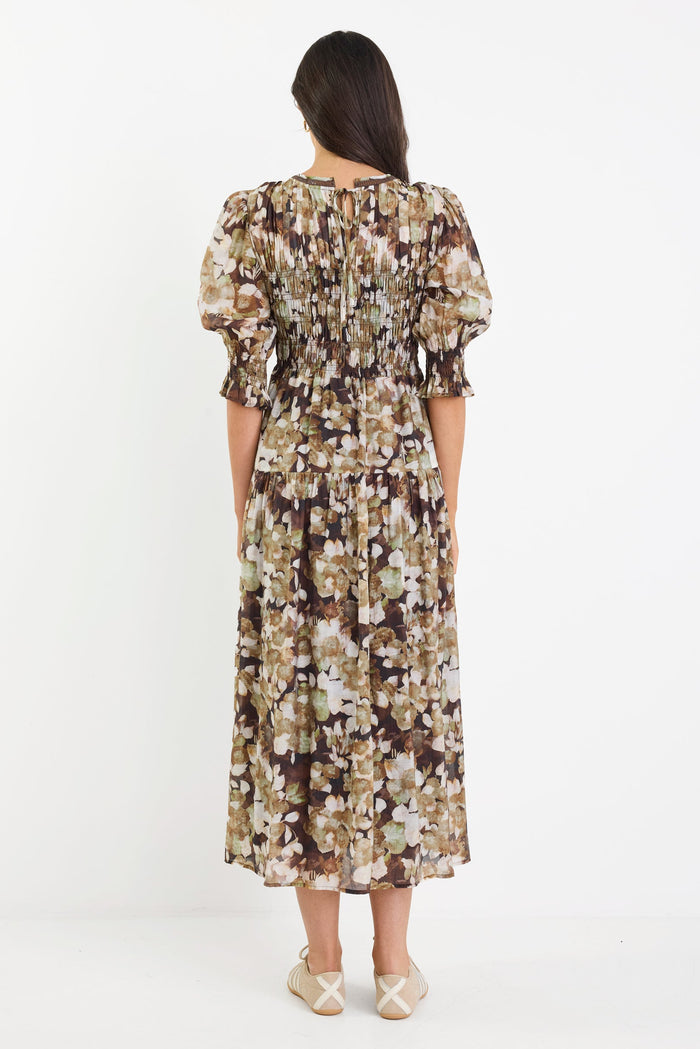Woman wearing a floral dress on a white background