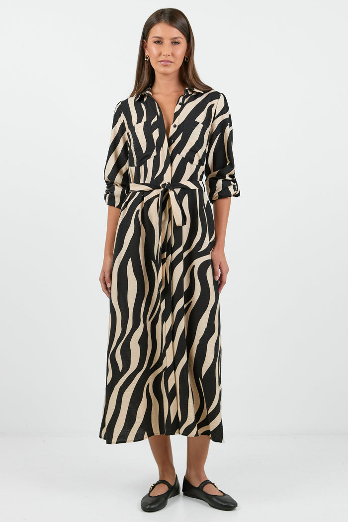 Woman wearing a zebra print dress on a white background