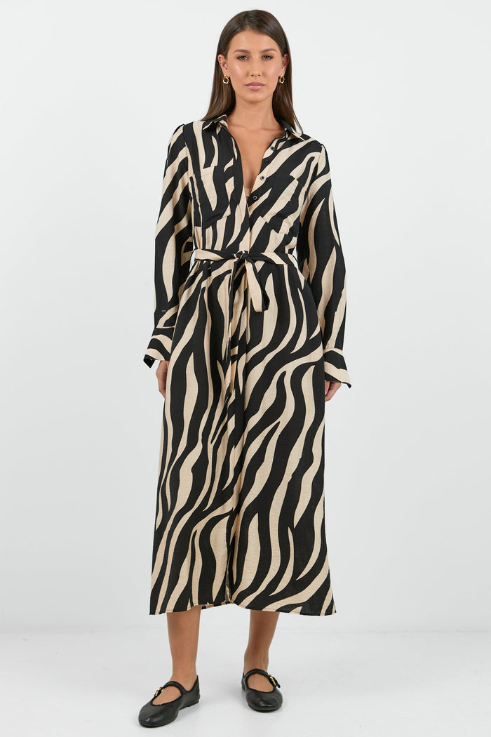 Woman wearing a zebra print dress on a white background