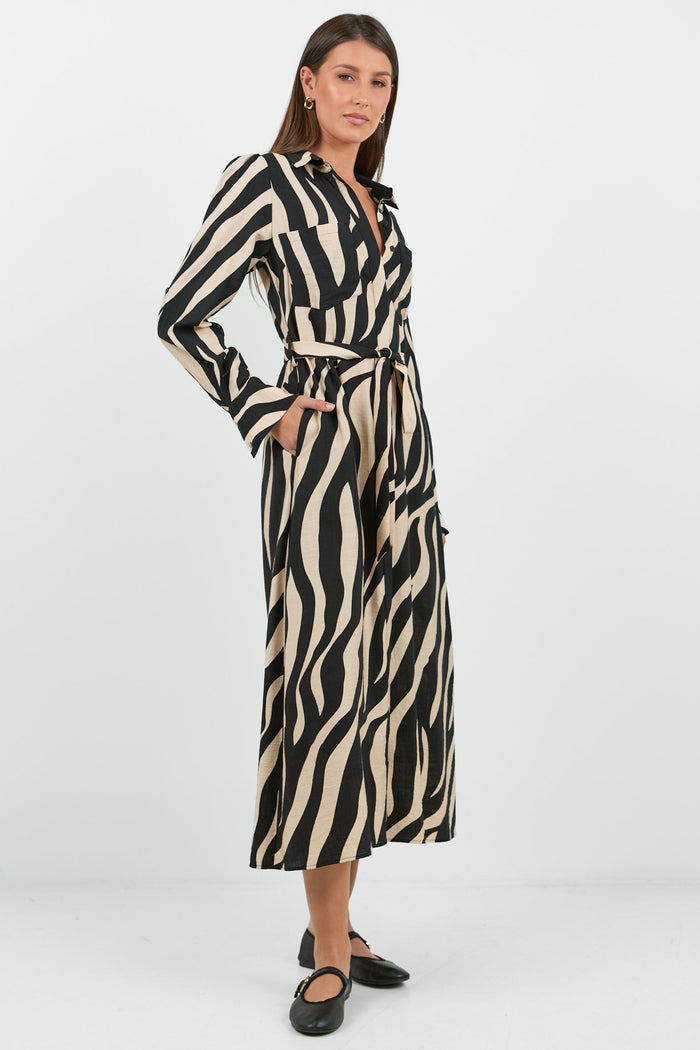 Woman wearing a zebra print dress on a white background