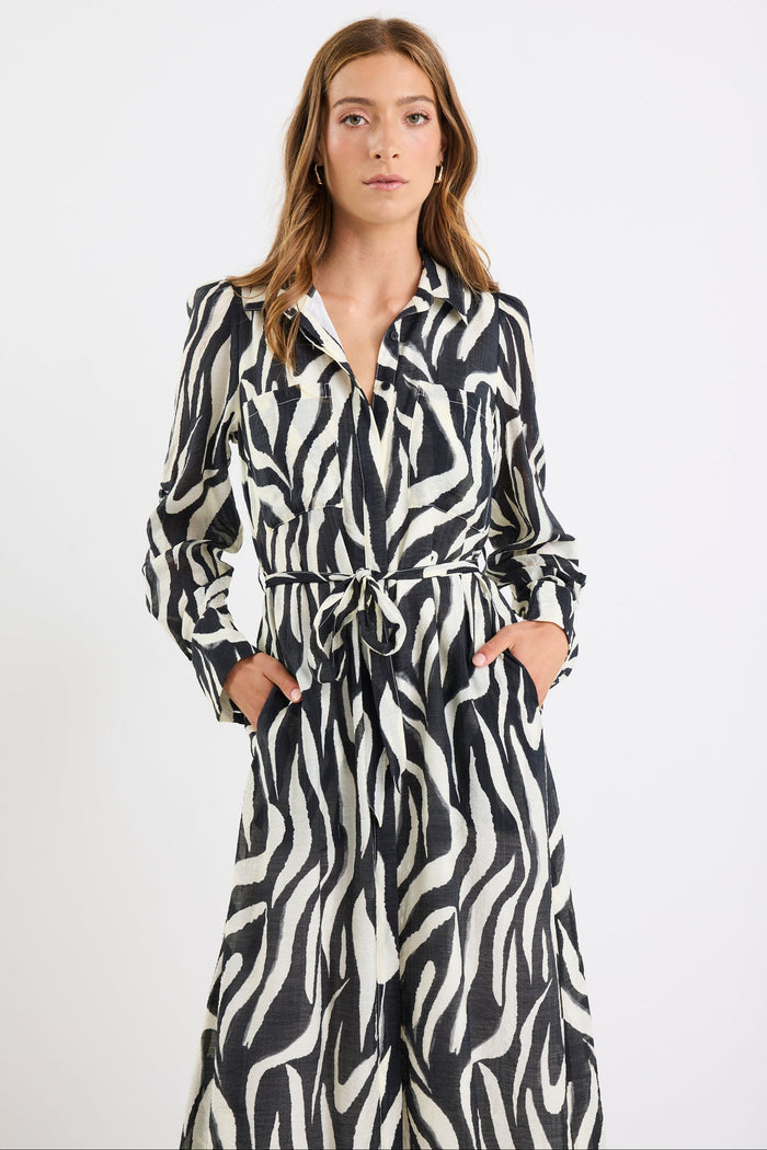 Woman wearing a zebra print outfit on a white background