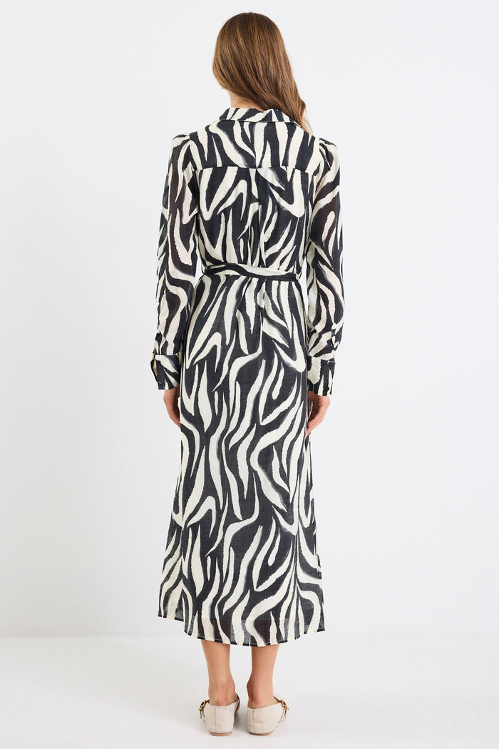 Woman wearing a zebra print dress on a white background