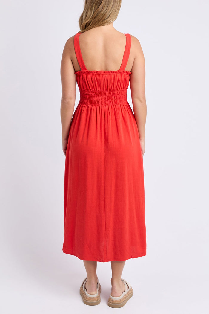 Woman wears a orange red maxi dress