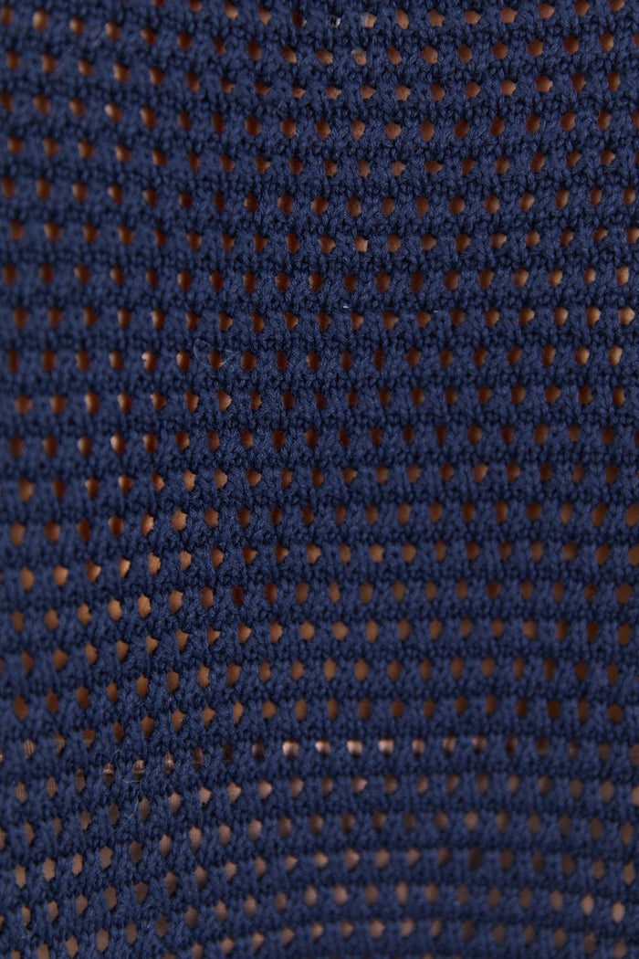 Close-up of a textured blue fabric with a subtle pattern