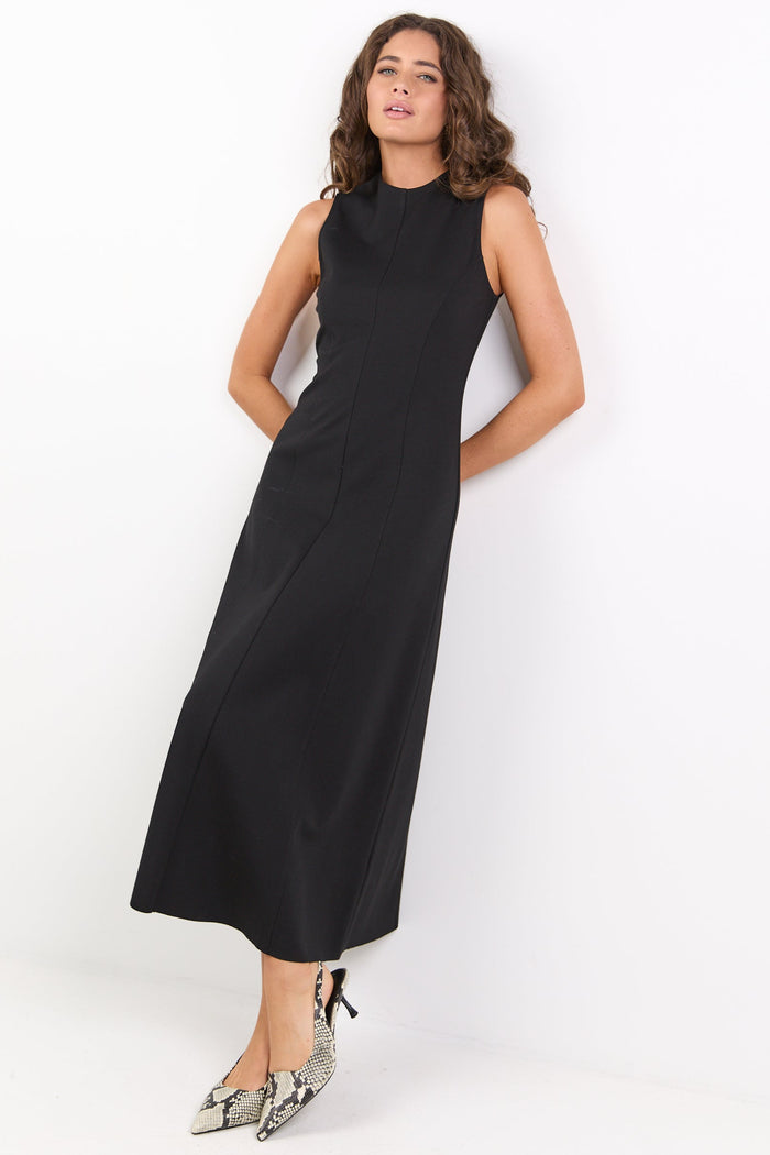 Woman wearing a black sleeveless dress against a white background