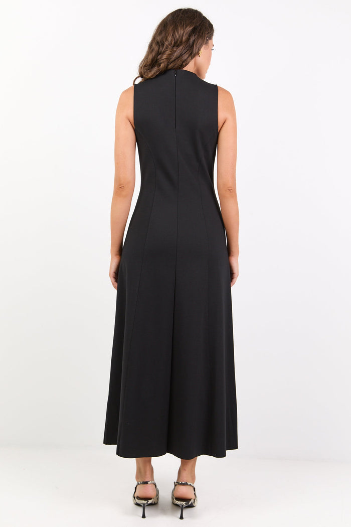 Woman wearing a black sleeveless dress on a white background