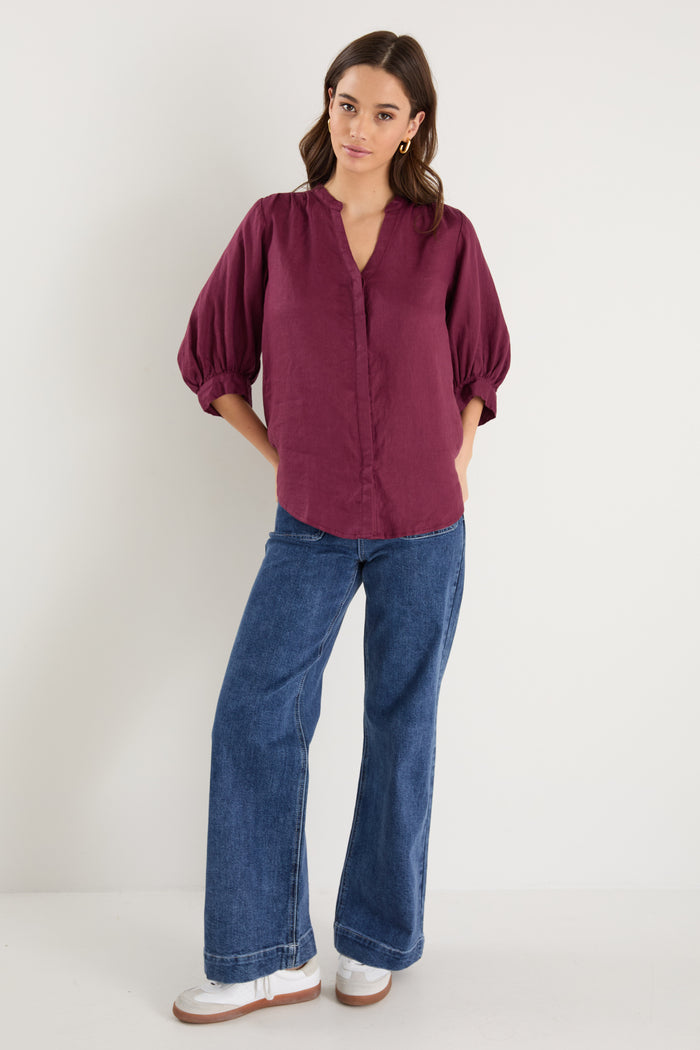burgundy blouse on model