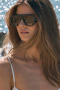 Woman wearing sunglasses with a blurred background