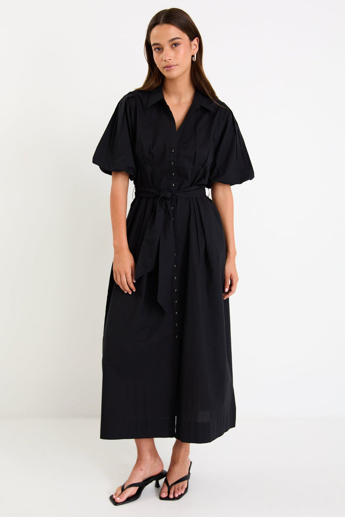 Woman wearing a black dress on a white background