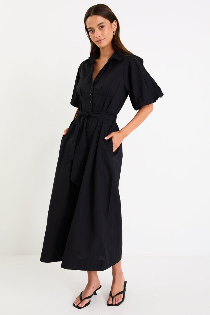 Woman wearing a black dress on a white background