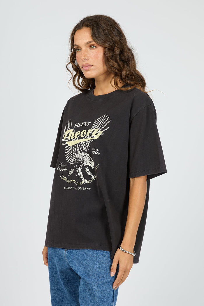 Woman wearing a black t-shirt with graphic design on a white background