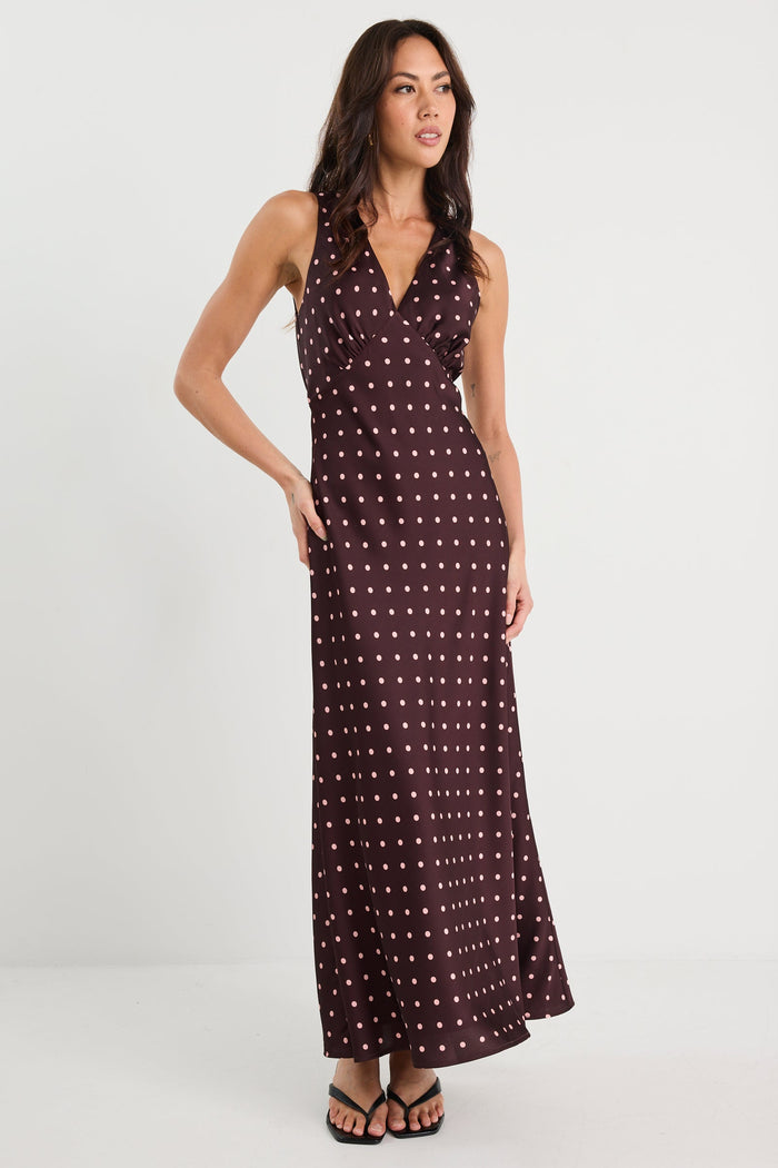 Woman wearing a patterned dress on a white background