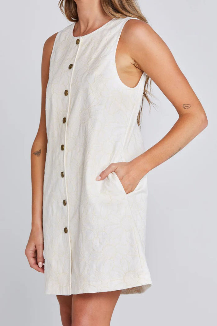 Woman wearing a light floral button down mini dress