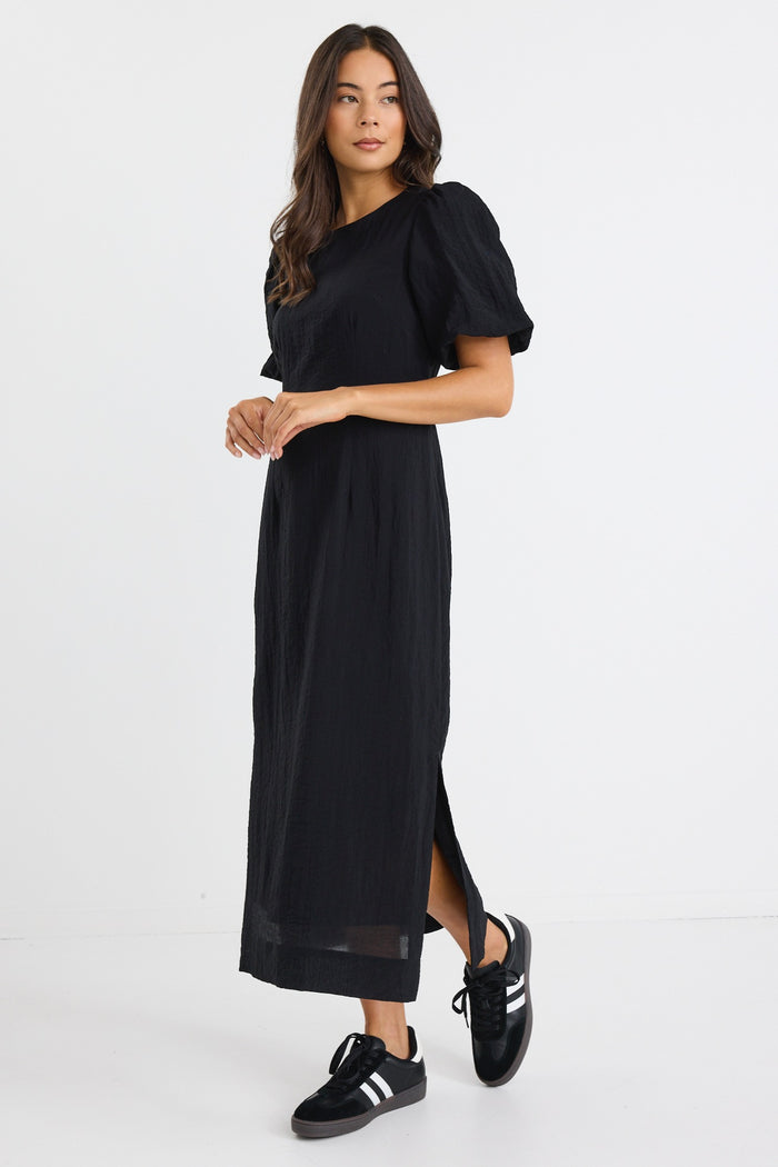 model wears a black puff sleeve midi dress