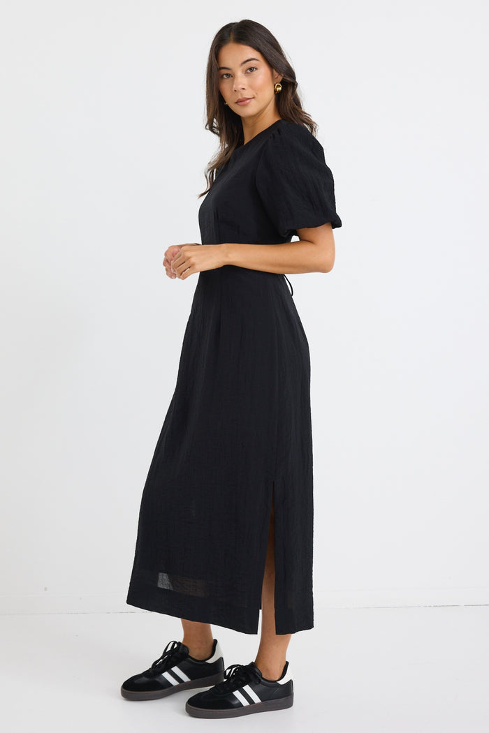 model wears a black puff sleeve midi dress