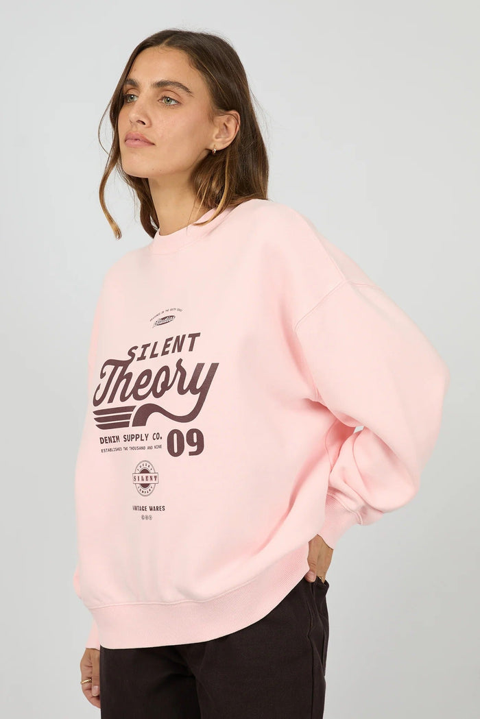 Woman wearing a pink sweatshirt with text on a gray background