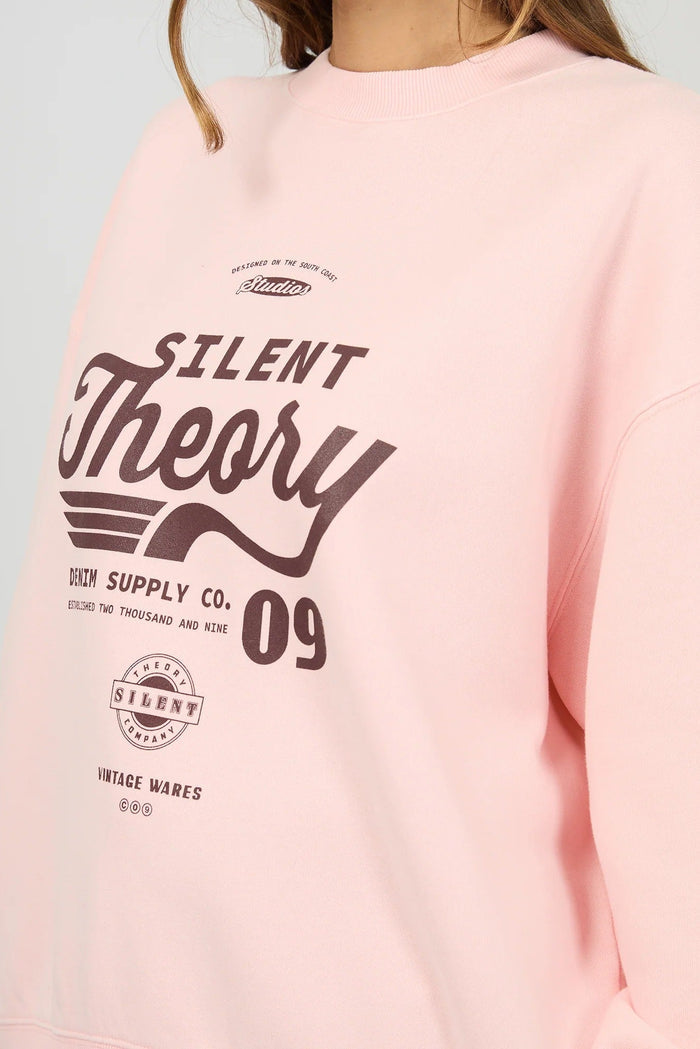 Pink sweatshirt with 'Silent Theory' text and graphics on a light gray background
