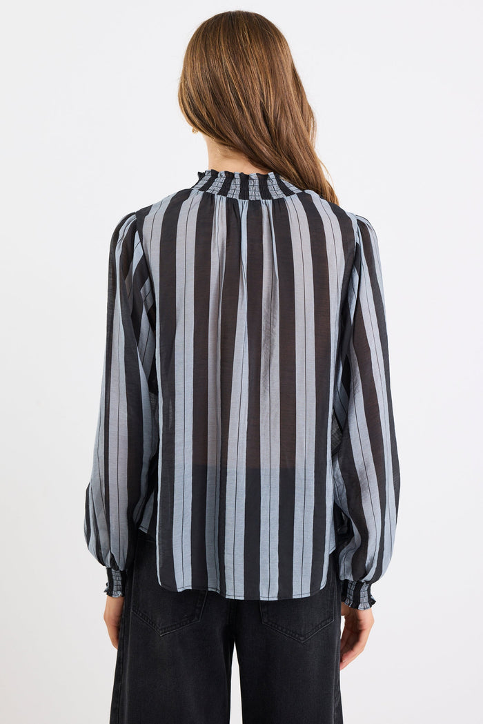 Person wearing a black and gray striped shirt on a white background